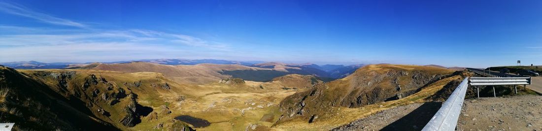 Panoramic view of mountains against blue sky