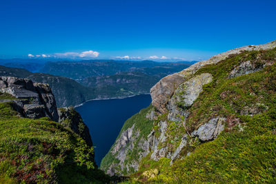 Scenic view of mountains against blue sky