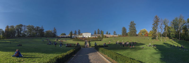 Group of people in garden against clear sky