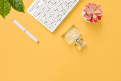 Directly above shot of laptop and book with pencil on table
