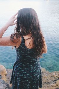 Beautiful woman standing at sea shore