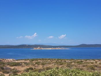 Scenic view of sea against blue sky