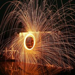 Close-up of wire wool spinning at night