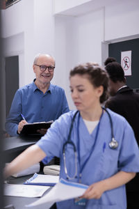 Female doctor explaining to patient in office