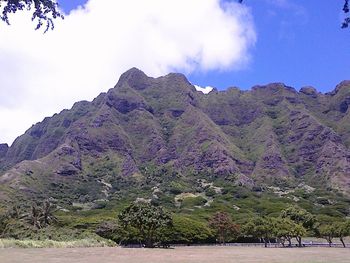 Scenic view of mountains against cloudy sky