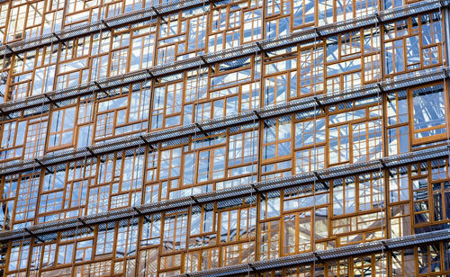 Low angle view of modern glass building in city