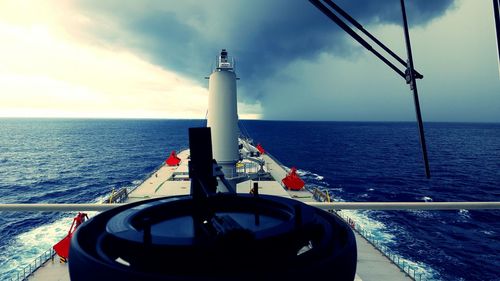 Boat sailing in sea against sky