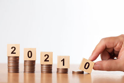 Midsection of person holding table against white background