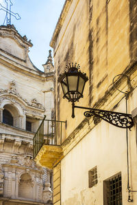 Low angle view of street light against building