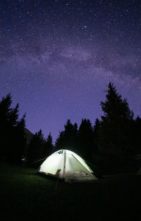 Scenic view of tent against sky at night