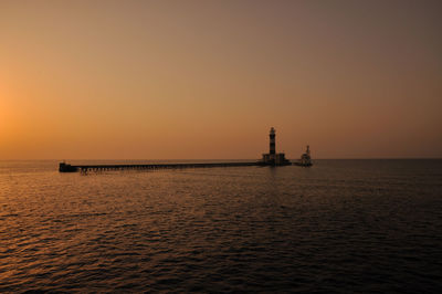 Scenic view of sea against clear sky during sunset