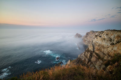 Scenic view of sea against sky at sunset