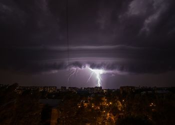 High angle view of buildings against lighting at night