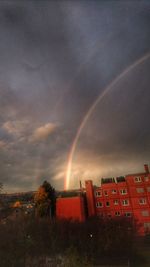 Rainbow over city at night