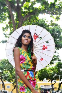 Portrait of young woman holding umbrella