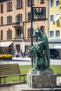 Statue against buildings in city