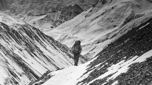 Person standing on snow covered mountain