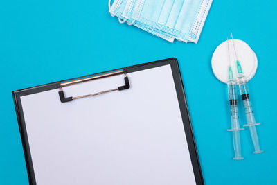 High angle view of pen on table against blue background