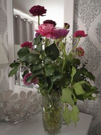 Close-up of rose flower vase on table at home