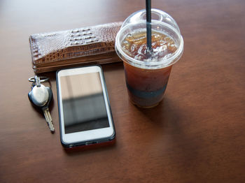 High angle view of coffee and laptop on table