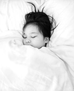 High angle view of cute baby boy sleeping on bed