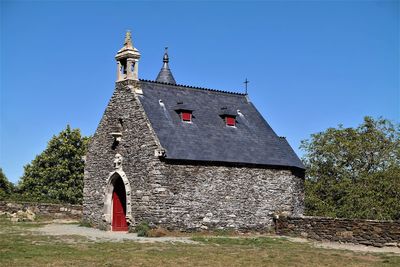 Low angle view of traditional building against clear blue sky