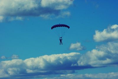 Low angle view of parachute against blue sky