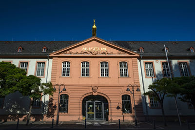 Low angle view of building against clear blue sky