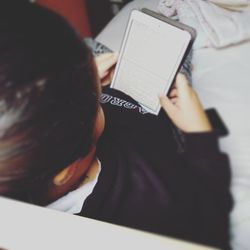 Rear view of woman reading book