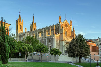 View of trees and buildings against sky