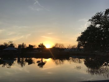 Scenic view of lake against sky at sunset