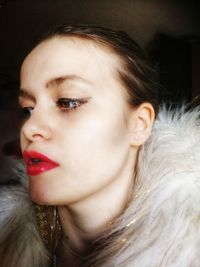 Close-up portrait of young woman looking away