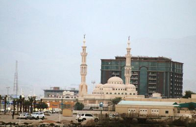 Buildings in city against clear sky