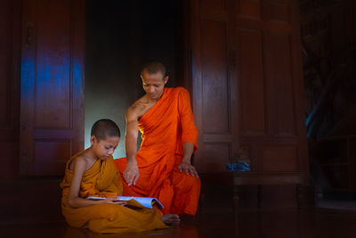 Monk teaching boy in monastery