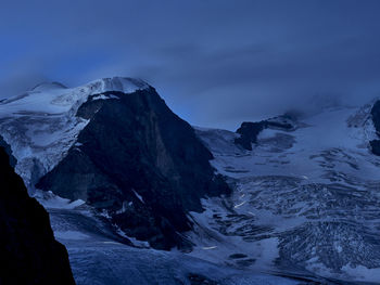 Scenic view of snowcapped mountains against sky at dawn