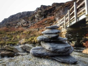 Close-up of stack of rocks against sky