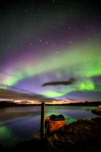 Scenic view of lake against sky at night