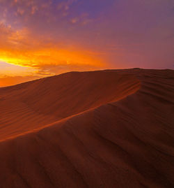 Scenic view of desert against sky during sunset