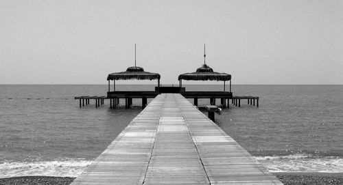 Pier on sea against clear sky