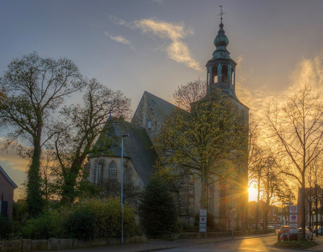 building exterior, architecture, built structure, tree, building, sky, plant, religion, nature, belief, spirituality, tower, place of worship, no people, city, travel destinations, low angle view, outdoors, spire