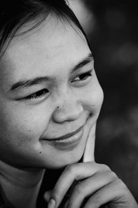 Close-up portrait of a smiling young woman