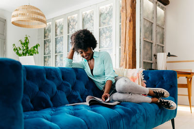 Young man sitting on sofa at home