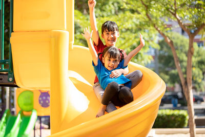 Rear view of boy playing in playground