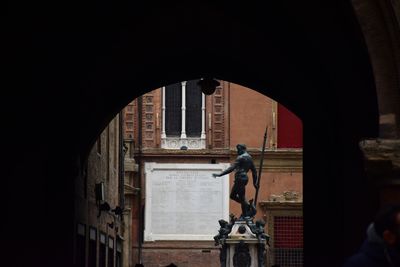 Low angle view of statue against historic building