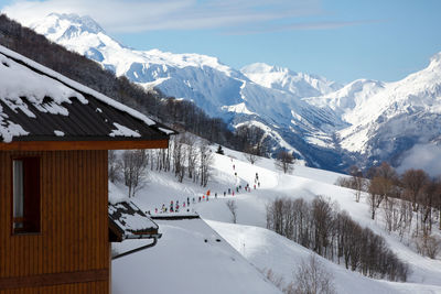 Scenic view of snow covered mountains against sky