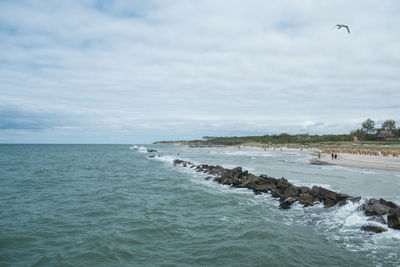 Scenic view of sea against cloudy sky