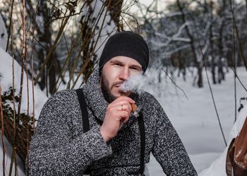 Portrait of young man in snow