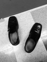 High angle view of shoes on tiled floor