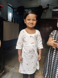 Portrait of smiling girl standing at home