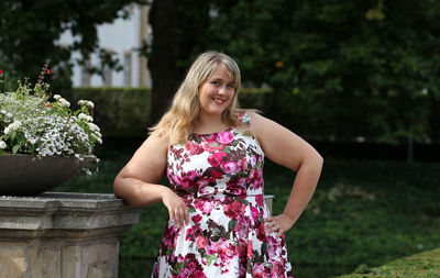 Happy girl standing in front of flower